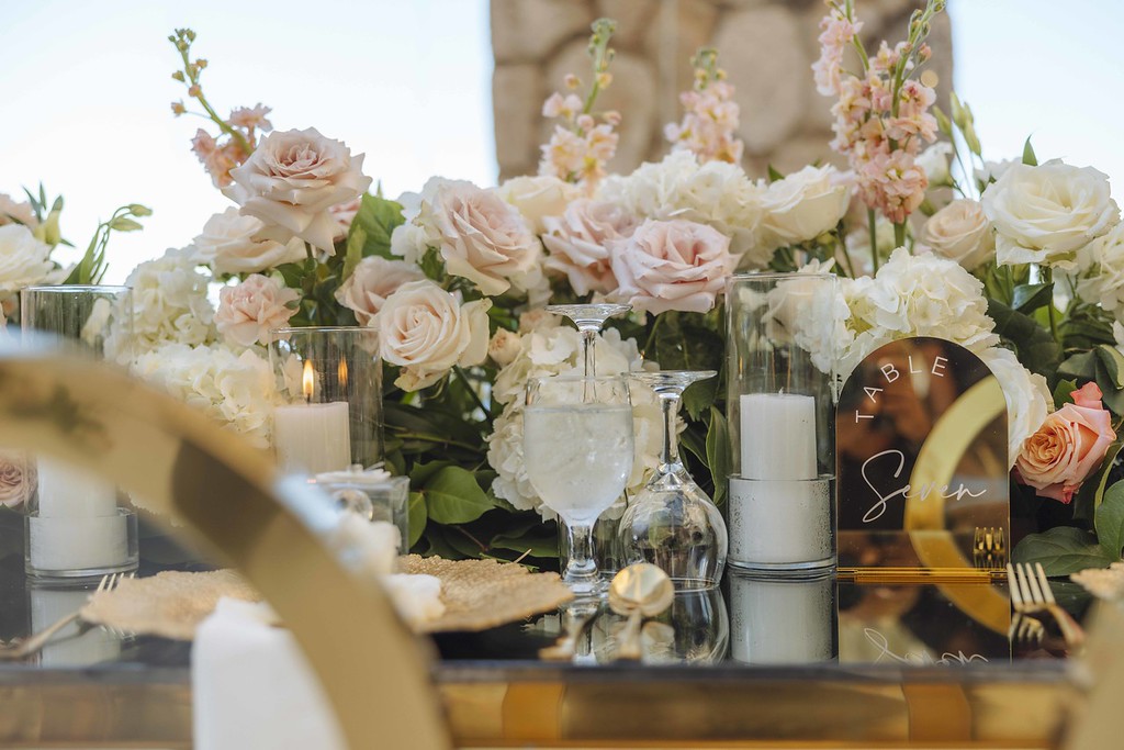 Reception table setting with pink roses and gold accents